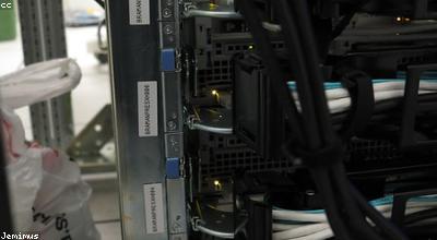 Rows of server hardware in a dim data center