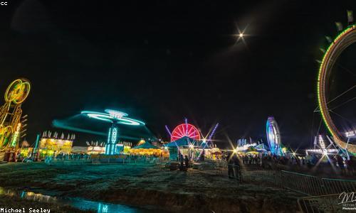 A lit-up carnival midway at night