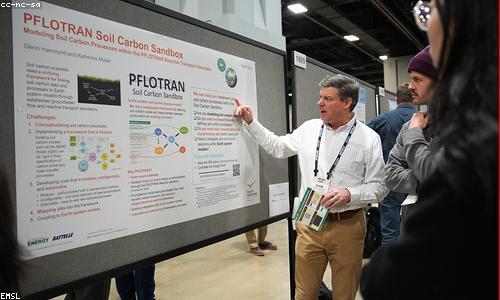 A researcher reviewing charts on a lab whiteboard