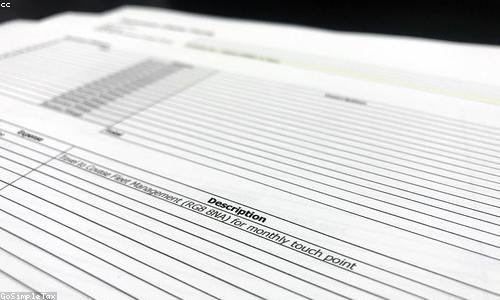 A hand filling out a paper form